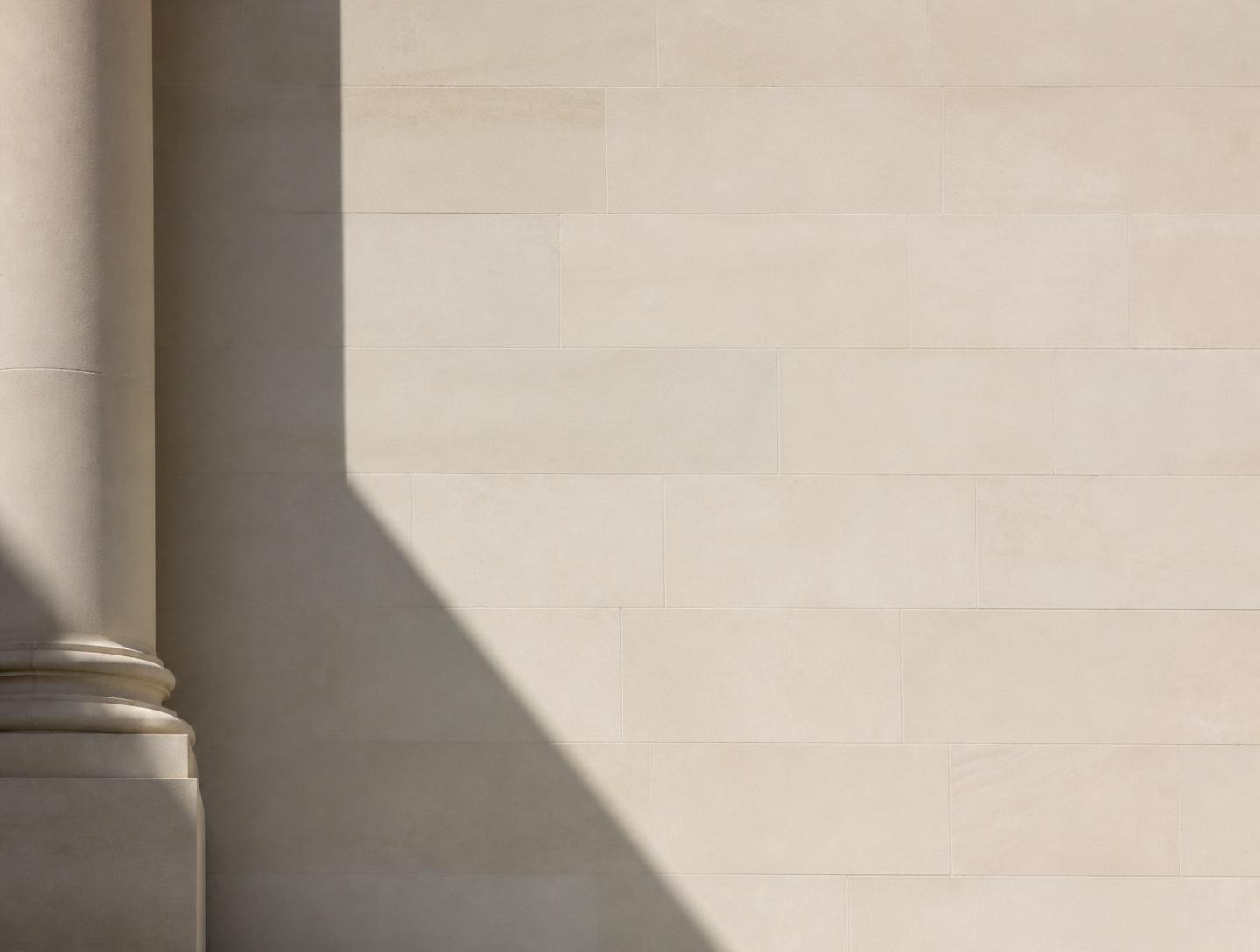 Daylight across a pale stone façade